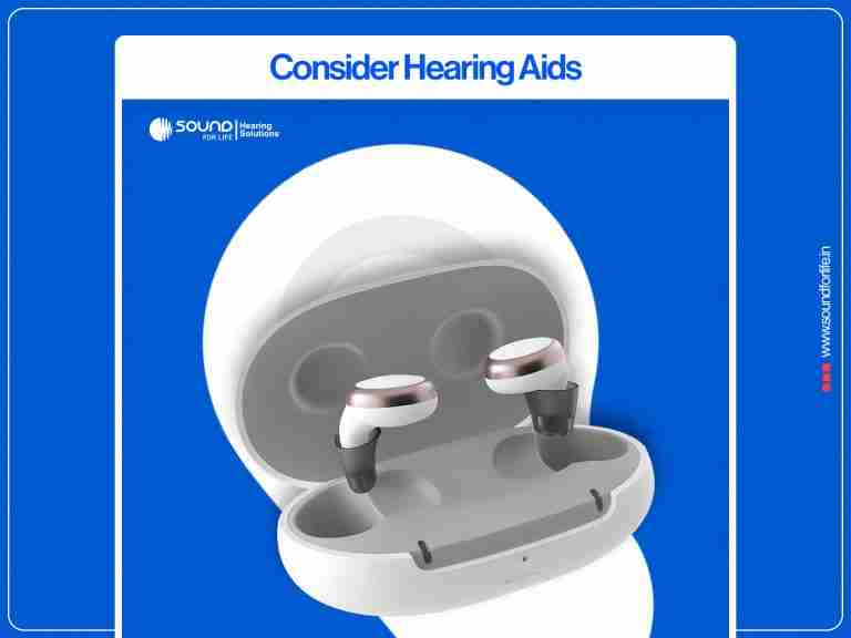 A pair of sleek, earbud-style hearing aids sitting inside an open charging case set against a blue promotional background with the heading "Consider Hearing Aids".
