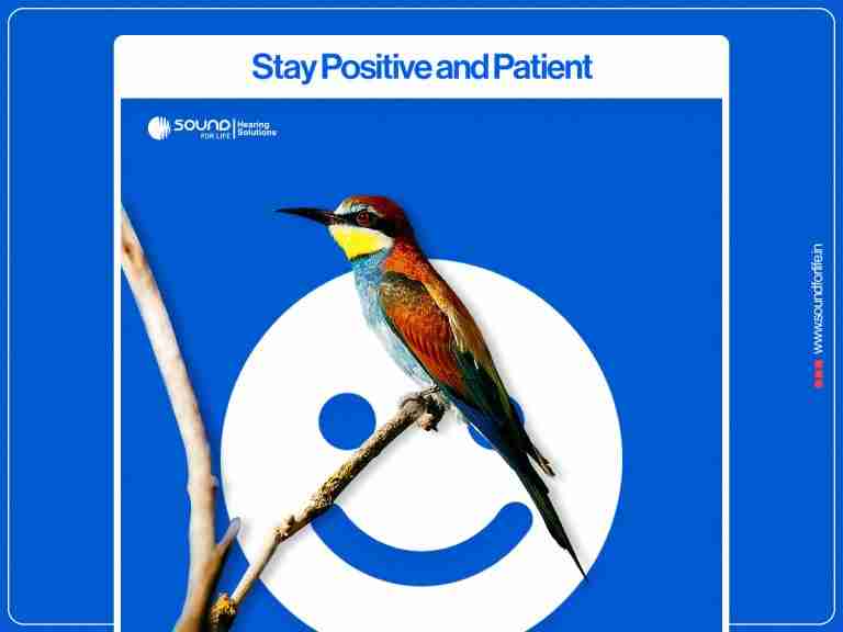 A colorful bird perched on a small branch in front of a white smiley face graphic against a blue promotional background with the heading "Stay Positive and Patient".