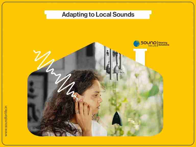 Adapting to local sounds: a woman cupping her ear, listening near hanging wind chimes